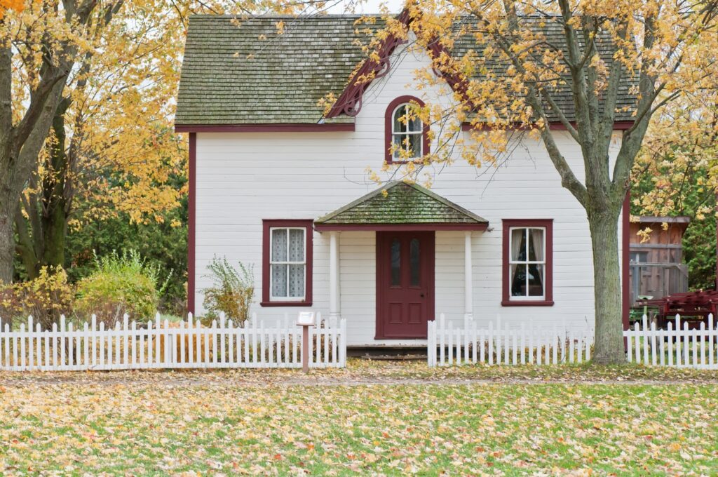 Small Home with Red Door and White PIcket Fence