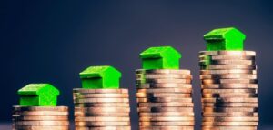 Stacks of coins with mini houses