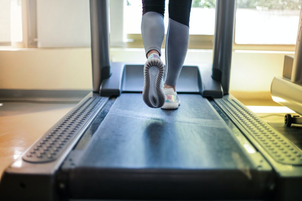 View of person's feet as they are running on a treadmill