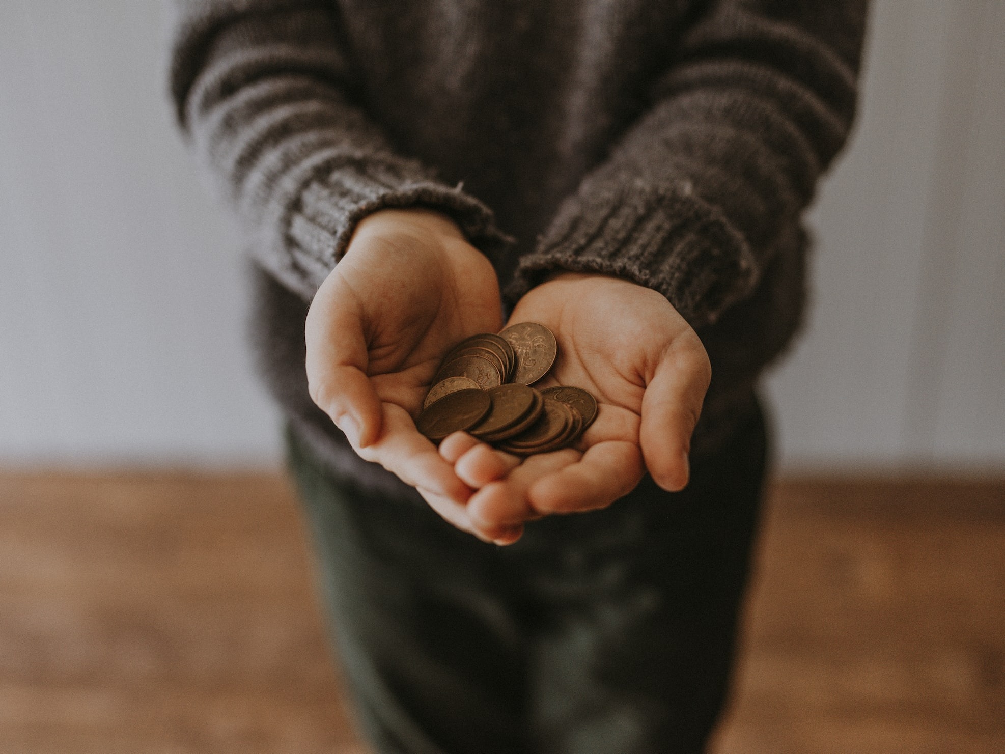 woman holding coins in her hands